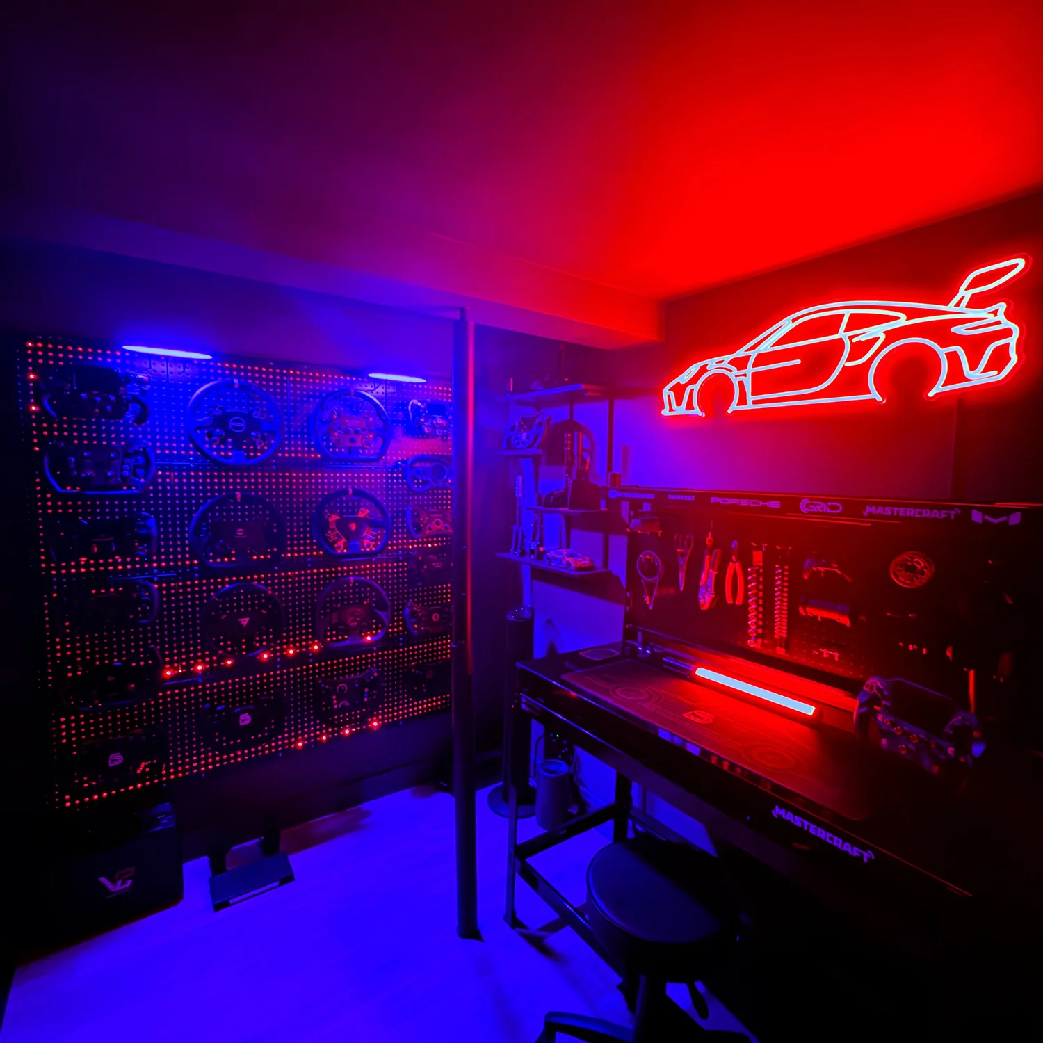 Inside The SimRacing Den studio, with sim racing equipment and neon lighting.